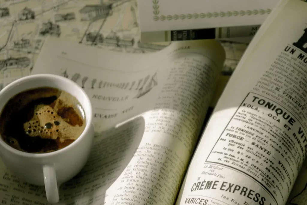 An espresso on an open old French newspaper