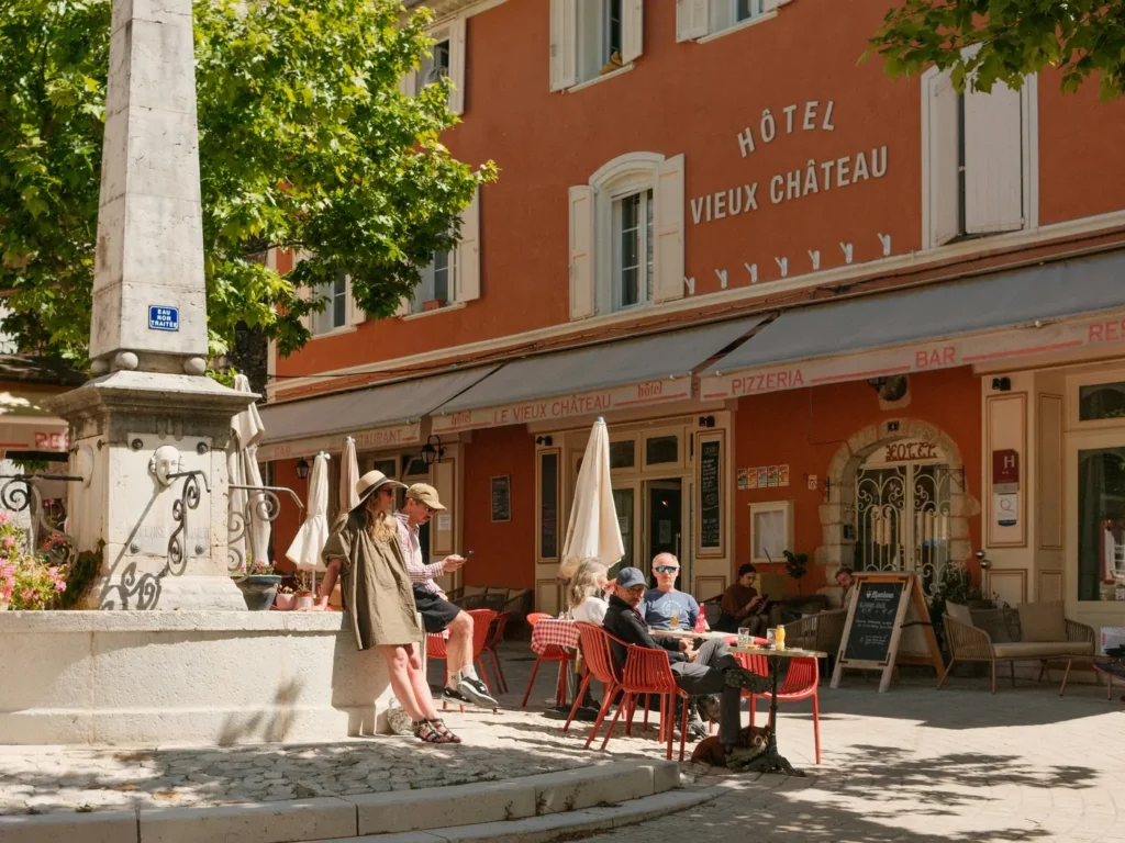 Café terrace on the village square of Aiguines, in Provence, with a chalkboard menu